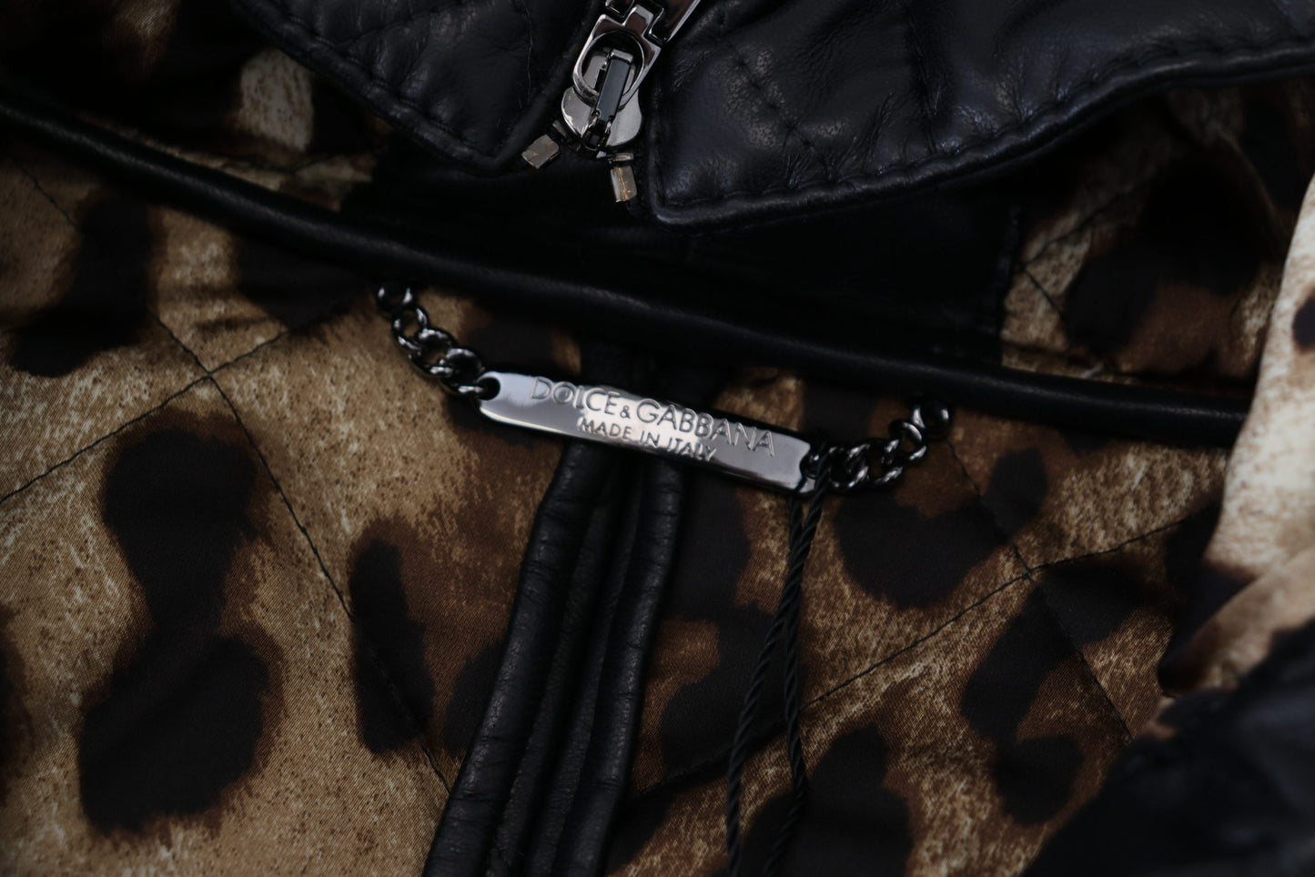 Schwarze gesteppte Lederjacke mit Kapuze und Knopf