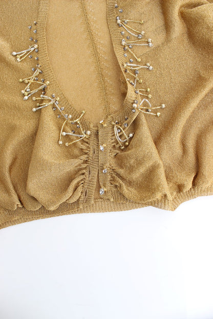 Goldfarbener Shrug mit Verzierungen